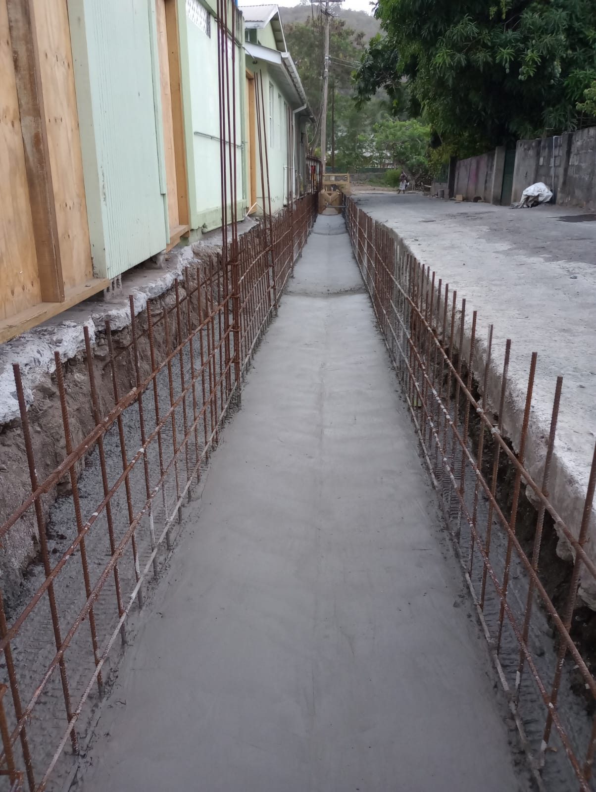 Finished concrete channel with workers