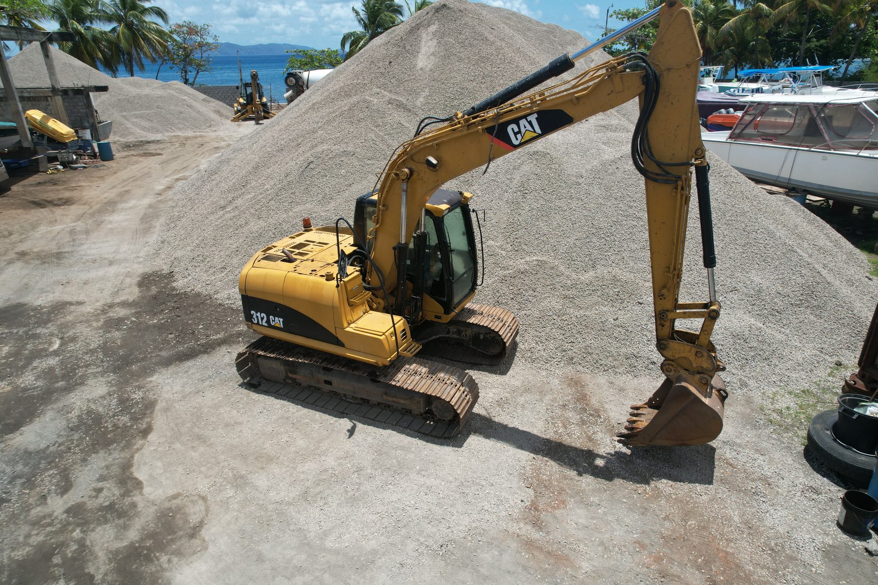 Caterpillar excavator working an aggregate stockpile